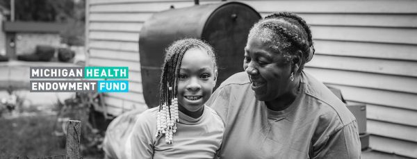 Black and white photo of grandma and granddaughter with Health Fund logo