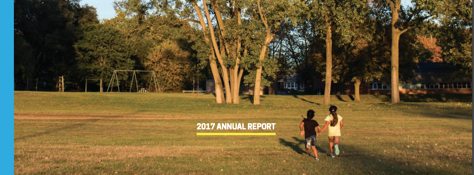 part of annual report cover with 2 children running outdoors