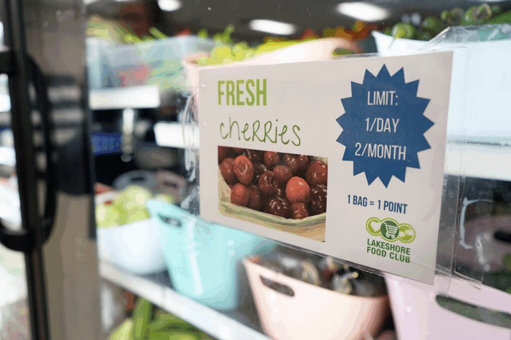 A sign advertising local cherries for sale at Lakeshore Food Club in Ludington, Michigan