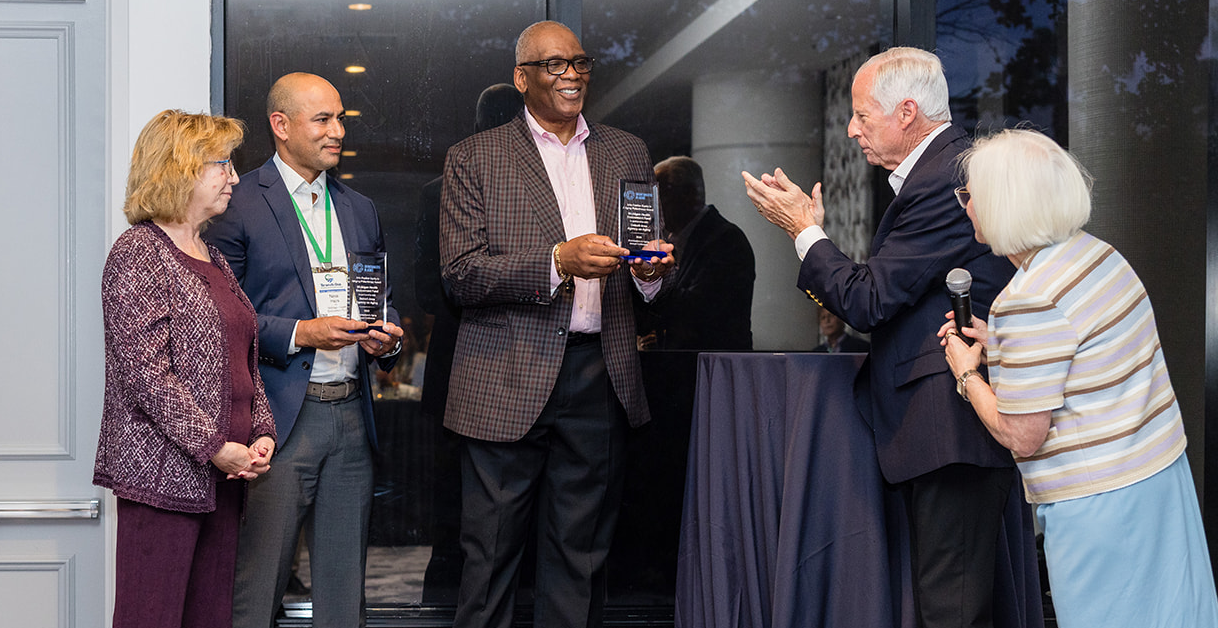 Award recipients on stage posing for a photo